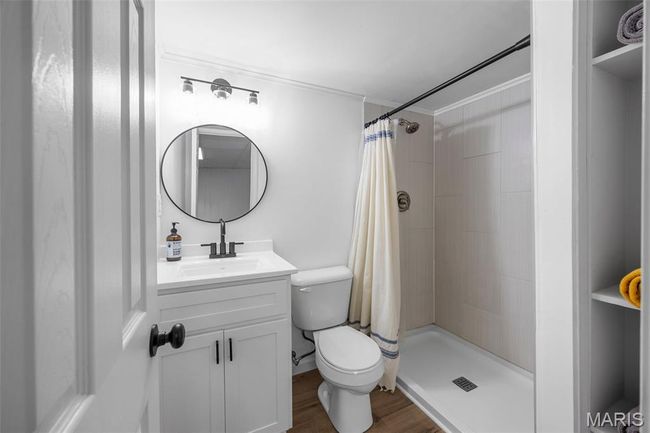 Lower Level Full bathroom featuring vanity, tiled shower, and LVP floors | Image 25