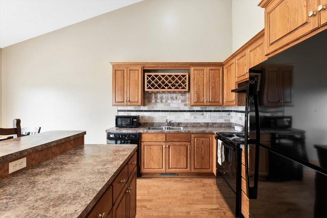 Kitchen includes newer appliances and plenty of cabinet space with beautiful oak finishes. | Image 14