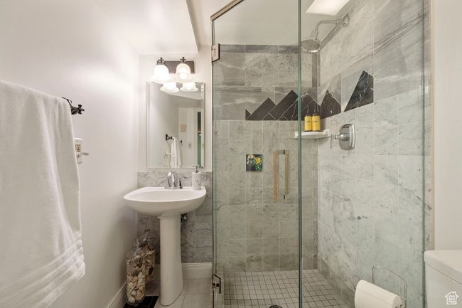 Full bathroom with a shower stall and tile patterned floors | Image 21