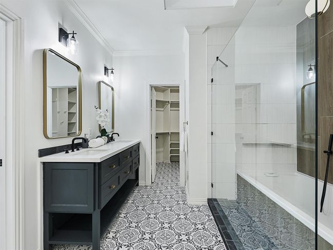 Full bath featuring a tile shower, ornamental molding, a tub, and a sink | Image 9