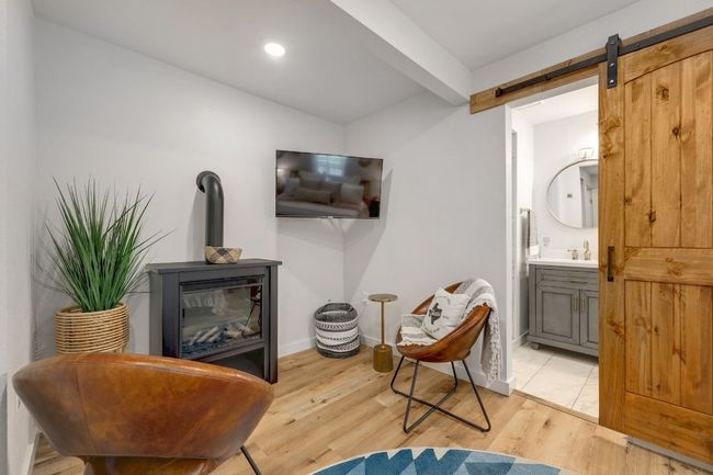 Sitting area in primary with electric fireplace | Image 21