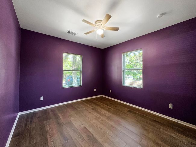 Unfurnished room with wood finished floors, a ceiling fan, and baseboards | Image 13