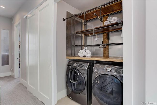 Laundry closet concealed by a large barn door when not in use | Image 35