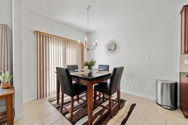 Dining space with sliding door access to private patio | Image 7