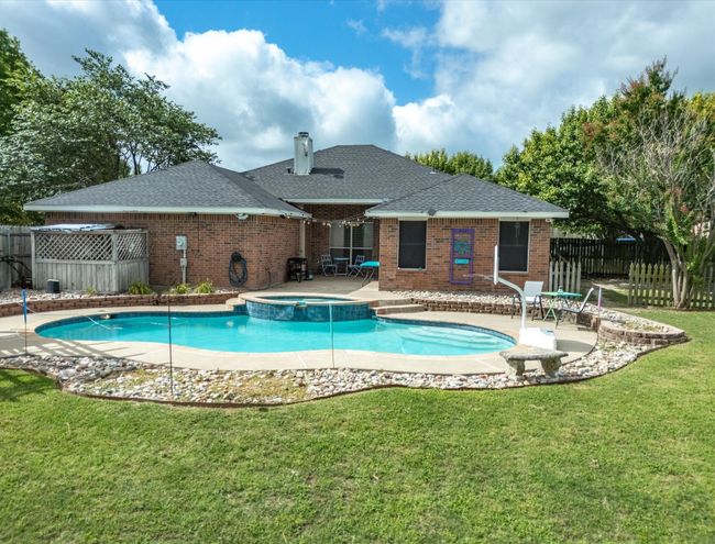 View of pool with a patio and a pool with connected hot tub | Image 35