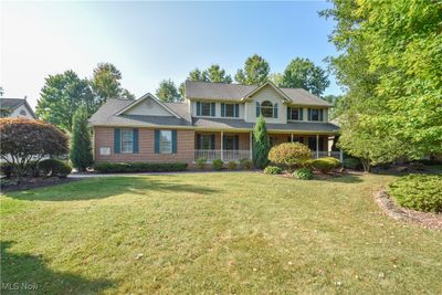 Colonial house with covered porch and a front yard | Image 1