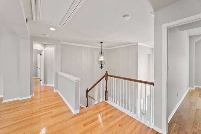 Hall with attic access, an upstairs landing, wood finished floors, and recessed lighting | Image 22