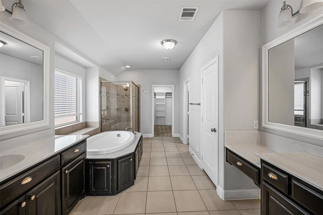 Full bath with tile patterned flooring, visible vents, a shower stall, a garden tub, and two vanities | Image 26