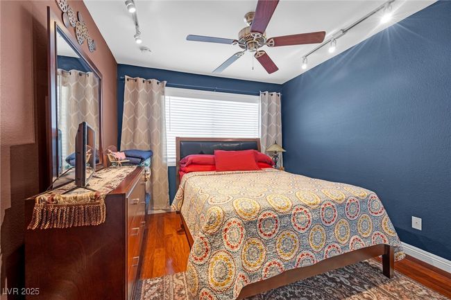 Bedroom featuring baseboards, ceiling fan, and wood finished floors | Image 19