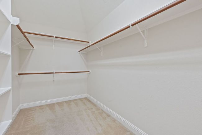 Walk in closet with carpet floors | Image 21