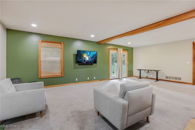 Carpeted living area with beam ceiling and recessed lighting | Image 12