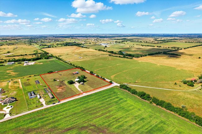 Aerial view of sparsely populated area featuring property parcel outlined | Image 8