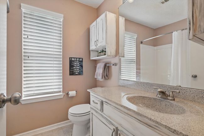 Full bathroom with tile patterned floors, vanity, curtained shower, baseboards, and toilet | Image 18