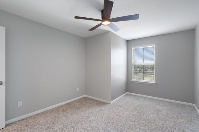 Carpeted empty room with a ceiling fan and baseboards | Image 20