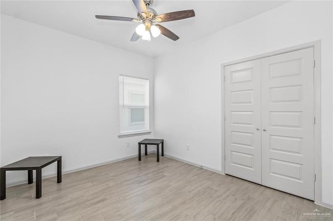 Spare room with light wood-style floors and a ceiling fan | Image 6