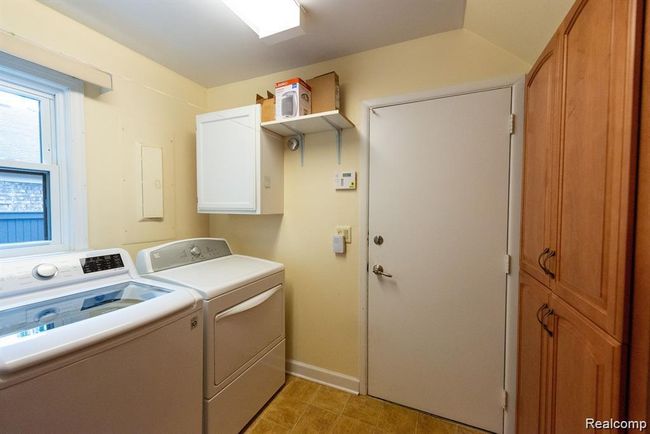 Washroom with cabinet space and washer and clothes dryer | Image 29