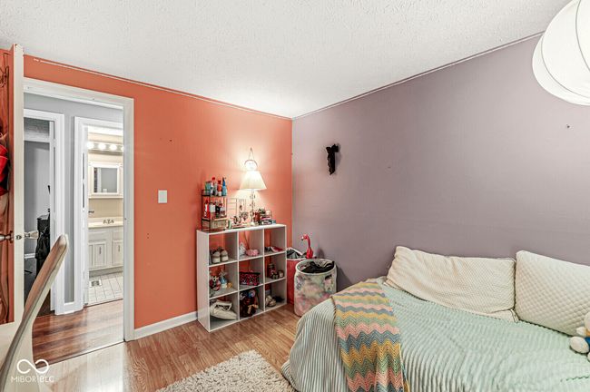 bedroom with wood finished floors and a textured ceiling | Image 18