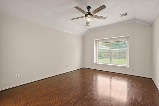 Spacious primary bedroom filled with natural light. | Image 10