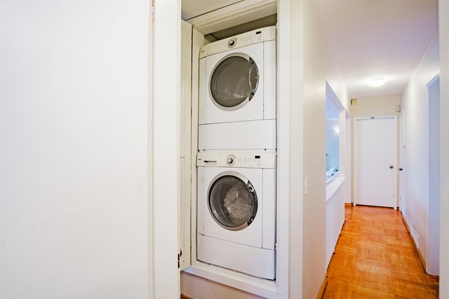 Washroom with stacked washing maching and dryer and laundry area | Image 14