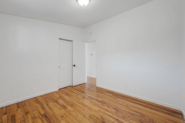 Unfurnished room featuring baseboards, visible vents, and light wood-style floors | Image 15