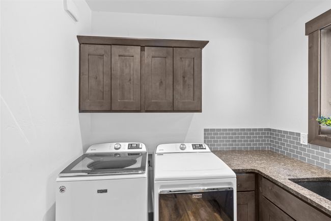 Laundry area with a sink, washing machine and dryer, and cabinet space | Image 35