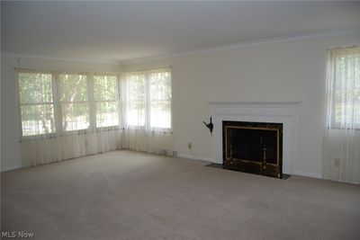 Unfurnished living room with carpet and crown molding | Image 3