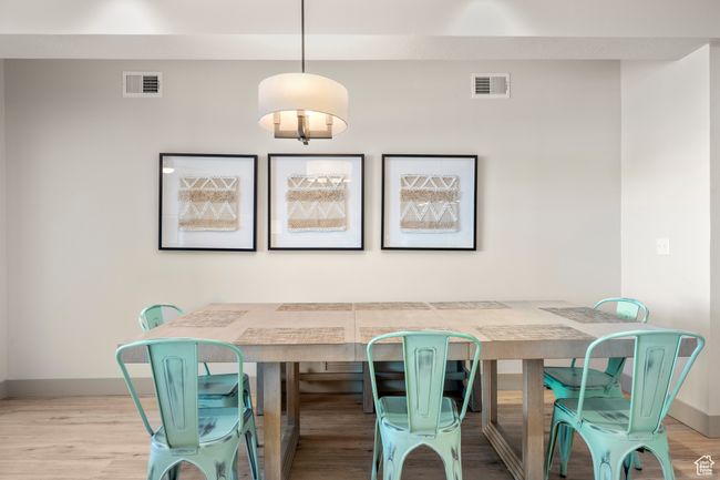 Dining space with baseboards and wood finished floors | Image 46
