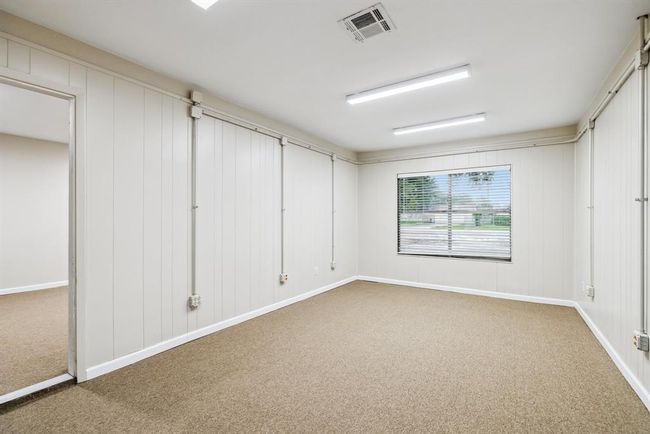 Original garage space was converted into a work center was used for a photography business. Could be a gameroom. Large window brings in fantastic light. New carpet, updated light fixtures, fresh paint throughout. New 2" blinds | Image 16