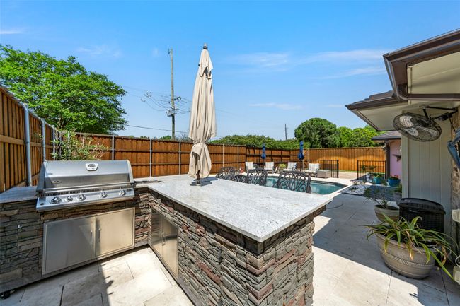 View of patio / terrace featuring an outdoor kitchen, a fenced backyard, and grilling area | Image 8