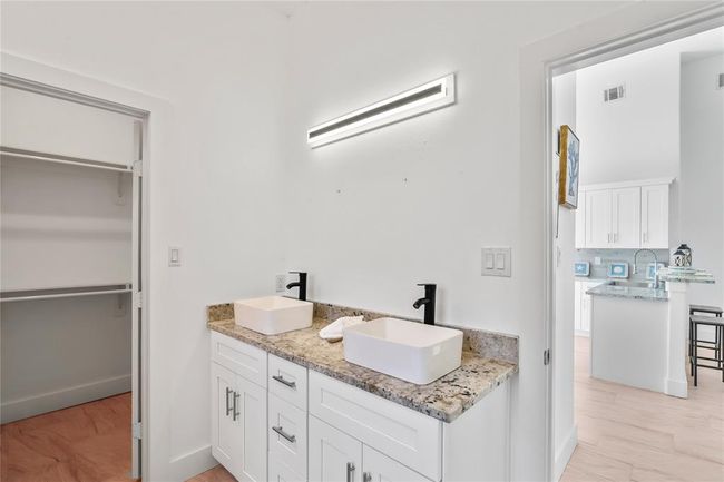 Stylish secondary bath featuring dual sinks for added convenience. | Image 14