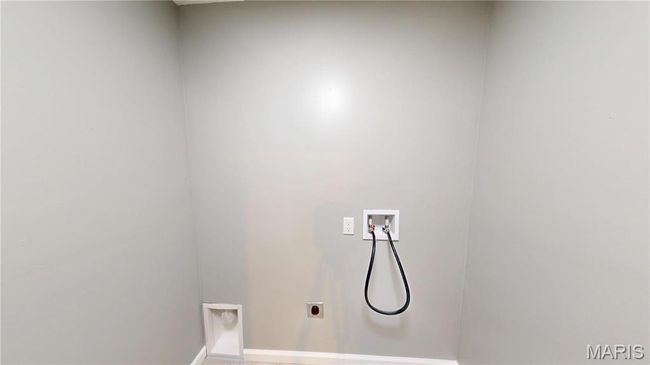 Laundry room featuring hookup for a washing machine, hookup for an electric dryer, and baseboards | Image 24