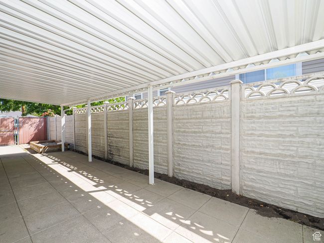 Fenced backyard with a patio | Image 31