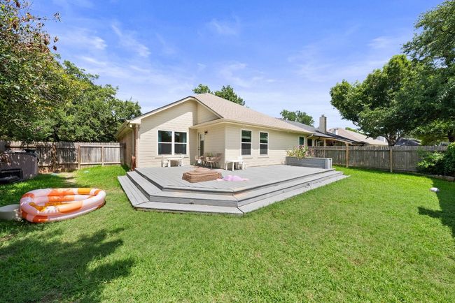 Rear view of property with a fenced backyard and a wooden deck | Image 27