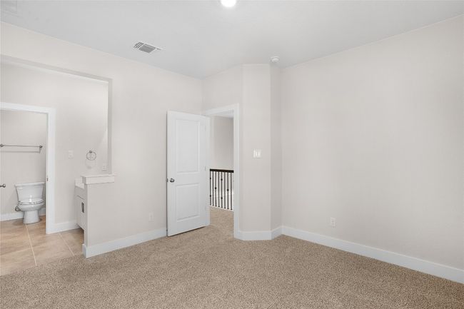 Unfurnished bedroom with light carpet, baseboards, and ensuite bathroom | Image 24