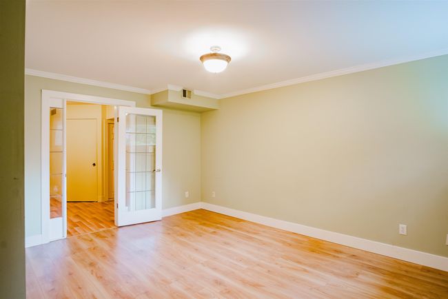 Spare room with light wood-type flooring, baseboards, and crown molding | Image 23