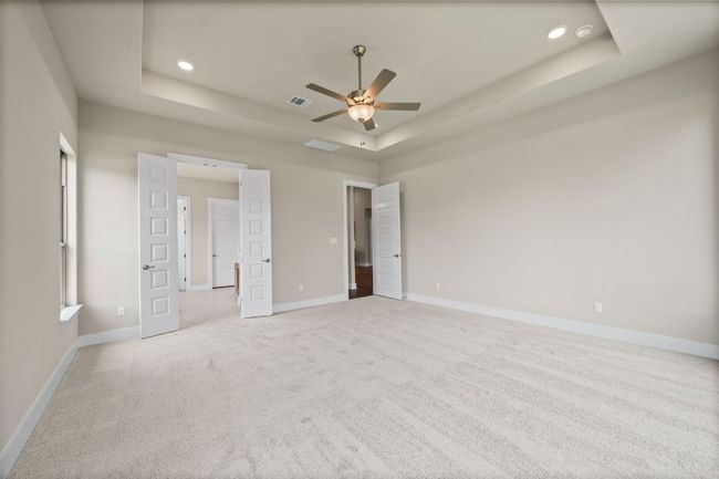 Primary Bedroom with tray ceiling and french doors to Primary Bath | Image 20