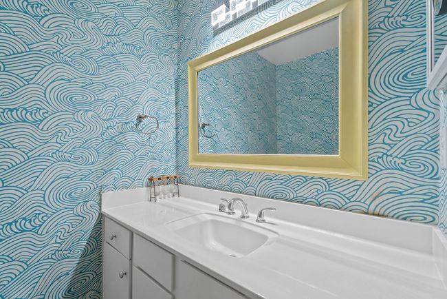 The primary ensuite bathroom is updated with chic designer wallpaper. | Image 18