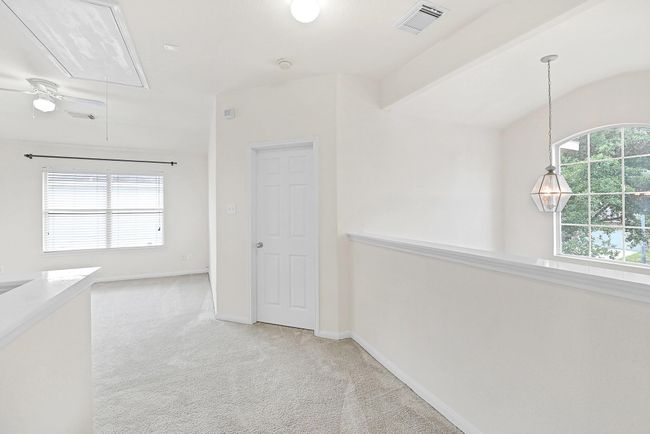 View upon ascending the stairs looking towards the game room and secondary bedroom. | Image 21
