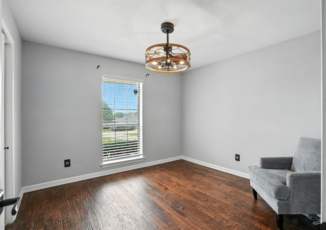 Unfurnished room featuring a chandelier and dark wood-style floors | Image 14