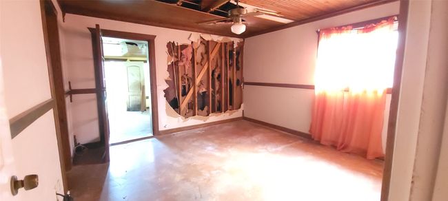 Spare room with concrete flooring, a ceiling fan, and wood ceiling | Image 20