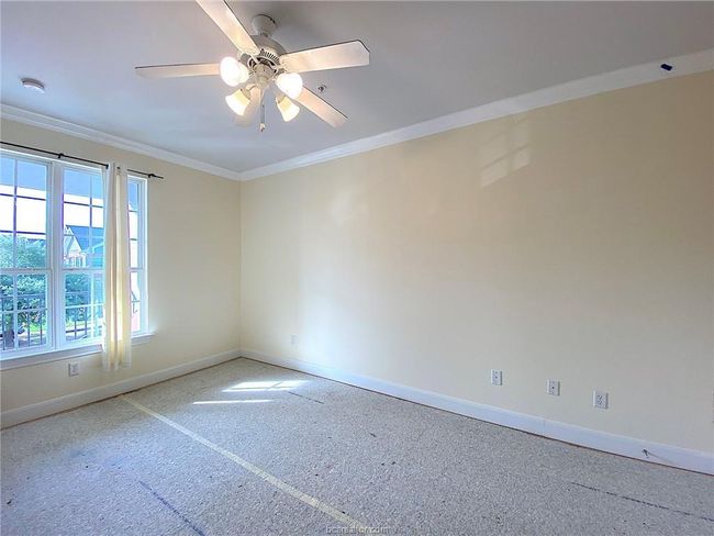 Spare room with baseboards, crown molding, and a ceiling fan | Image 5