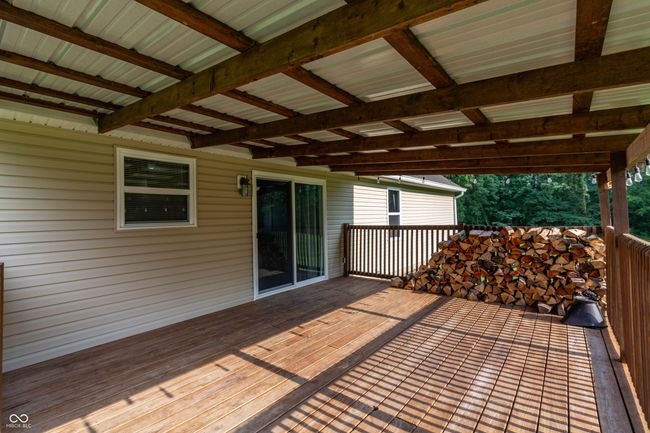 Covered rear deck is a great space to relax and unwind. | Image 19