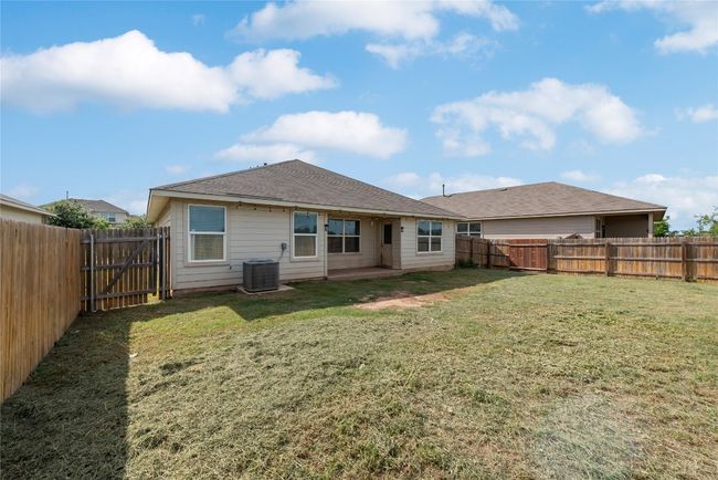 Back of property with a fenced backyard and roof with shingles | Image 23