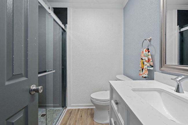 Hall bath has large walk-in shower with bench. | Image 27