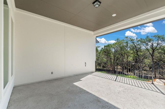 Expansive covered patio overlooks a serene, heavily wooded .54-acre lot. | Image 26