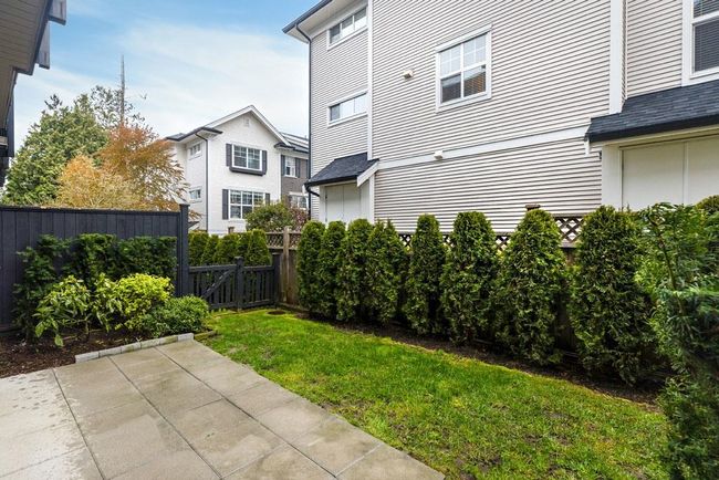 View of yard with fence and a patio area | Image 14