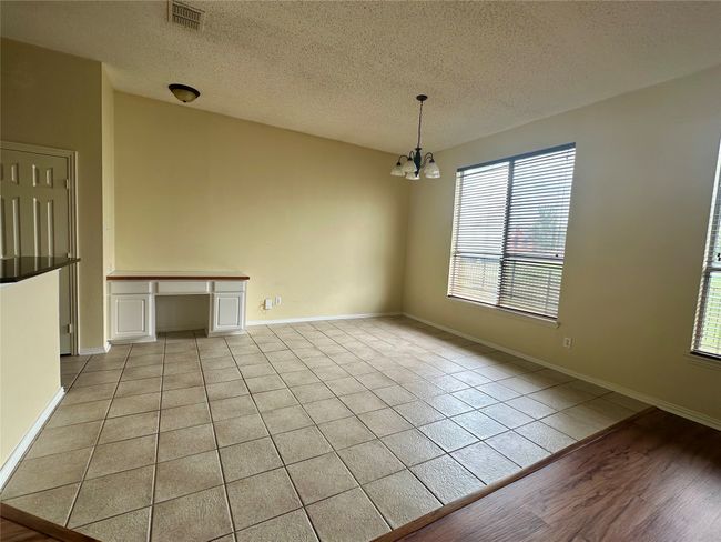 Unfurnished room featuring a chandelier and a textured ceiling | Image 7