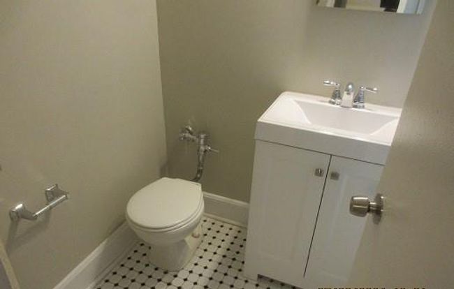 Bathroom featuring vanity, tile patterned flooring, and toilet | Image 5