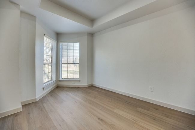 Empty room with light hardwood / wood-style floors and a tray ceiling | Image 13