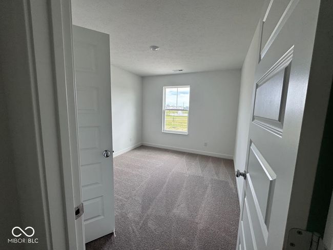 spare room featuring carpet floors and a textured ceiling | Image 4